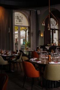 a restaurant with tables and chairs and a large window at Frimurarehotellet; Sure Hotel Collection by Best Western in Kalmar