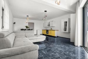 a living room with a couch and a kitchen at Villa Viola in Lovran