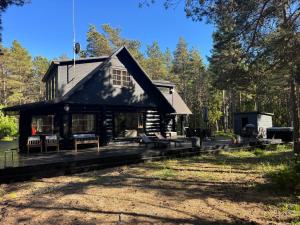 a log cabin in the woods with a yard at Wild Beach Spa in Kihelkonna