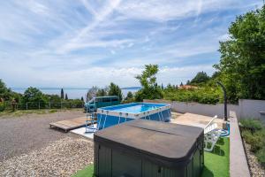 a swimming pool in a yard with a house at Villa Viola in Lovran