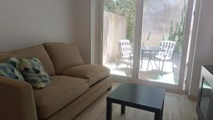 a living room with a couch and a table at Tomarhousing - Secret Garden in Tomar