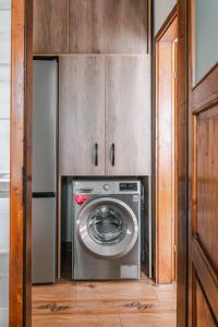 a kitchen with a washing machine and a refrigerator at Apartament de închiriat in Borsec +29 photos
