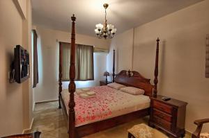 a bedroom with a wooden bed and a chandelier at Dalya Life in Göcek