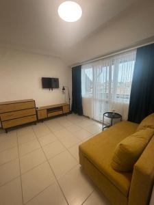 a bedroom with a bed and a tv in a room at Апартаменти Лилия 2 in Primorsko