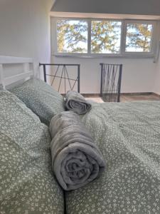 a blanket on a bed in a room with a window at Hedona227 in Perlez