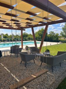 a patio with chairs and a swimming pool at Hedona227 in Perlez +13 photos