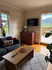 a living room with a couch and a coffee table at Leave It All in Venabygd