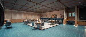 a restaurant with tables and chairs in a room at Orchid Parc Bengaluru - Manyata Business Park in Bangalore