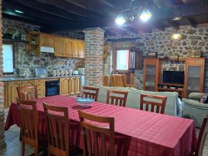 a kitchen with a table with a red table cloth at Casa Nardo in Benia de Onís