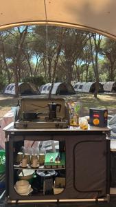 a grill in the back of a camper van with food at Bella Tents - Camping Vibes in Marina di Grosseto