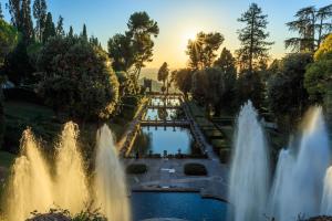 a view of fountains in a park at sunset at Il Posto delle Rose 2 in San Polo dei Cavalieri