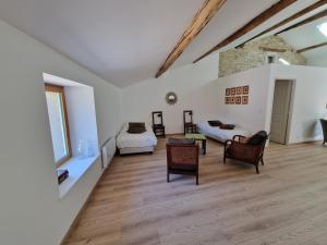 a large white room with two beds and chairs at La Ferme Duval in Vaudémont