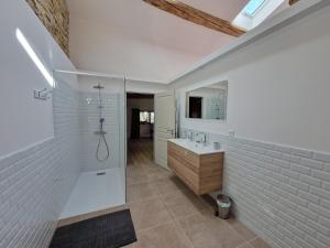 a bathroom with a shower and a sink at La Ferme Duval in Vaudémont
