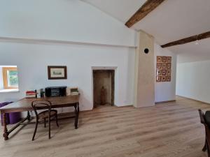 an empty room with a wooden table and chairs at La Ferme Duval in Vaudémont +5 photos