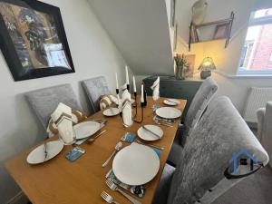 a dining room table with plates and candles on it at 28 Victoria Terrace, Bedlington, ground floor in Bedlington