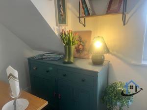 a blue dresser with a lamp on top of it at 28 Victoria Terrace, Bedlington, ground floor in Bedlington