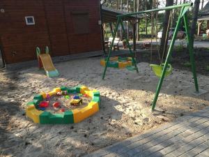 a playground with play equipment in the sand at Domki Piaskowa in Boszkowo-Letnisko