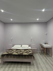 a white room with a bed and a desk at Exclusive Apartments "Lviv Vernygory 14", Modern Apartments with Self Check-in in Lviv +66 photos