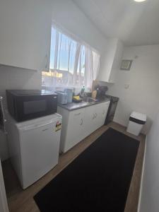 a small kitchen with a sink and a counter at Te Whare Whitiora in Hamilton