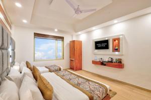 a bedroom with a bed and a tv on the wall at Hotel Vedas Heritage - Karol Bagh - Newly Renovated in New Delhi +76 photos