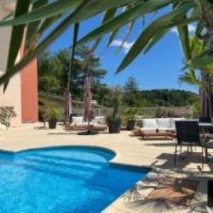 a swimming pool in front of a house at Hôtel de Charme By Arts & Millésimes in Essoyes