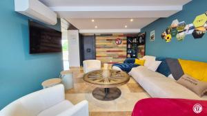 a living room with a couch and a table at Le Tarare in Guipy