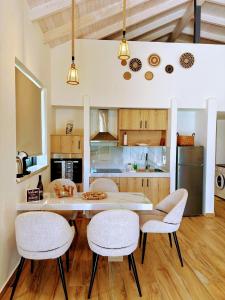 a kitchen with a table and chairs in a kitchen at LefkoParga Luxury Suites in Parga