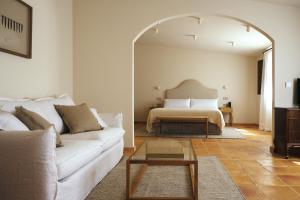 a living room with a white couch and a bed at Palacio de Paradinas in Santa María la Real de Nieva +21 photos