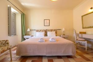 a bedroom with a bed with two towels on it at Gaia accommodation Hydras in Hydra