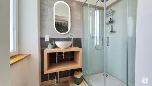 a bathroom with a sink and a glass shower at Le Tarare in Guipy +24 photos