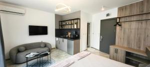 a living room with a couch and a tv at Guesthouse Odesos in Sozopol +83 photos