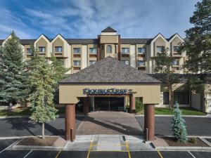 a building with a sign in front of a parking lot at DoubleTree by Hilton Hotel Flagstaff in Flagstaff