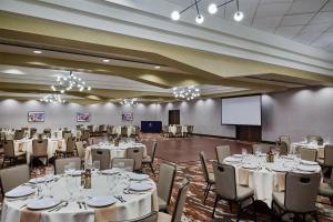 a banquet hall with tables and chairs and a screen at DoubleTree by Hilton Hotel Flagstaff in Flagstaff +50 photos