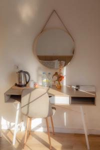 a desk with a chair and a mirror at Hostal San Miguel by Croma in Estepona +43 photos