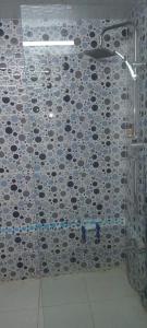 a bathroom with a shower with a tile wall at Akari said in Rabat +37 photos