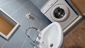 a bathroom with a sink and a washing machine at Caterina House in San Lucido