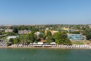 an aerial view of a beach with umbrellas at KYMA STAY - Beachfront apartments in Pálioura