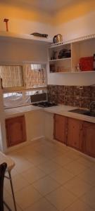a kitchen with wooden cabinets and a counter top at Akari said in Rabat