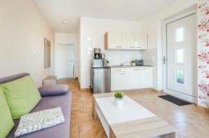 a living room with a couch and a table at Ferienwohnung Sonneneck in Kachlin