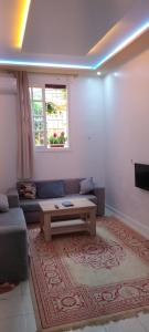 a living room with a couch and a coffee table at Akari said in Rabat