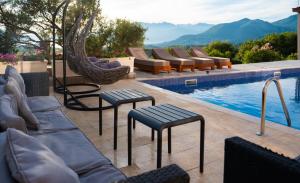 a swimming pool with lounge chairs and a swimming pool at Dorado Apartments in Kavač