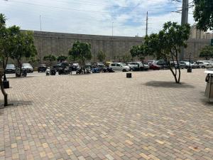 a parking lot with a bunch of parked cars at Cozy Crib Stays in Greater Noida +10 photos