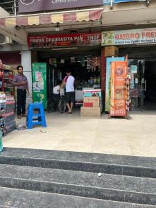 a man standing in front of a store at Cozy Crib Stays in Greater Noida