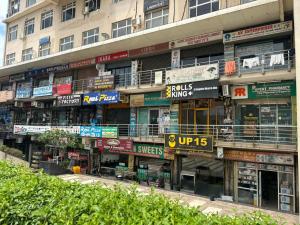 a building with many signs on the side of it at Cozy Crib Stays in Greater Noida