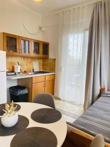 a kitchen and dining room with a table and a refrigerator at FERRUM house in Hanioti