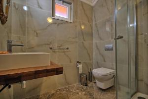 a bathroom with a shower and a sink and a toilet at Dalya Life in Göcek