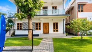 a view of a house with a surfboard at Zenways in Varkala