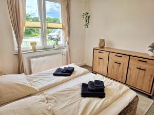 two beds in a bedroom with towels on them at Nicos Ferienwohnung in Grevesmühlen - ABC628 in Grevesmühlen