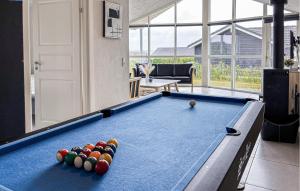 a pool table with balls on it in a living room at Nice Home In Haderslev With Sauna in Haderslev +18 photos
