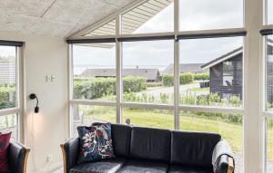 a living room with a couch and a large window at Nice Home In Haderslev With Sauna in Haderslev